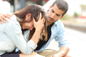 Muslim man comforting a sad girl mourning